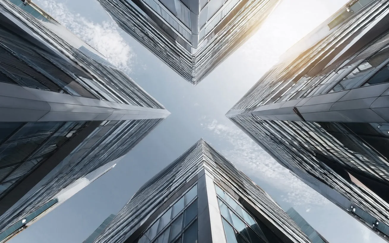 worm's-eye view of four modern buildings with glass fronts