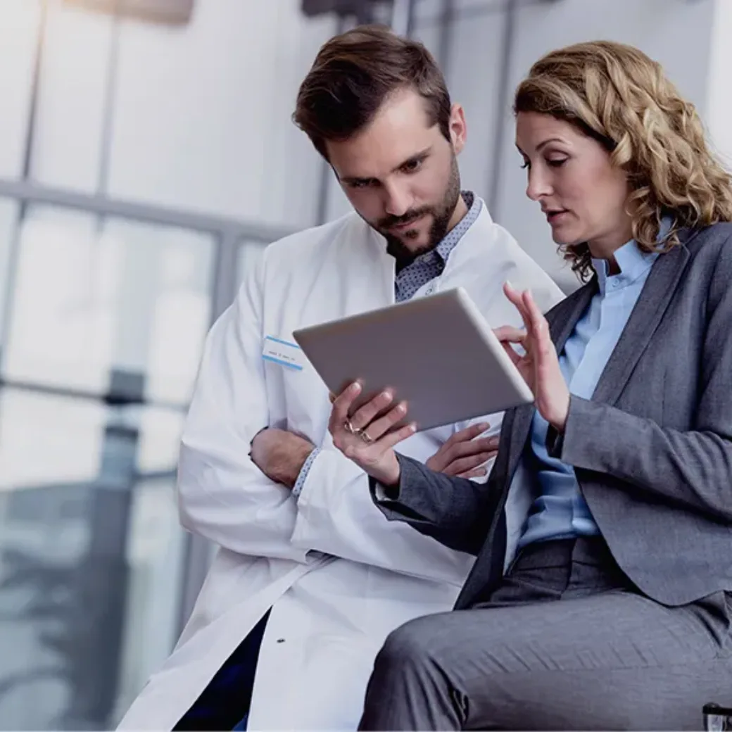 Businesswoman with tablet talking with doctor