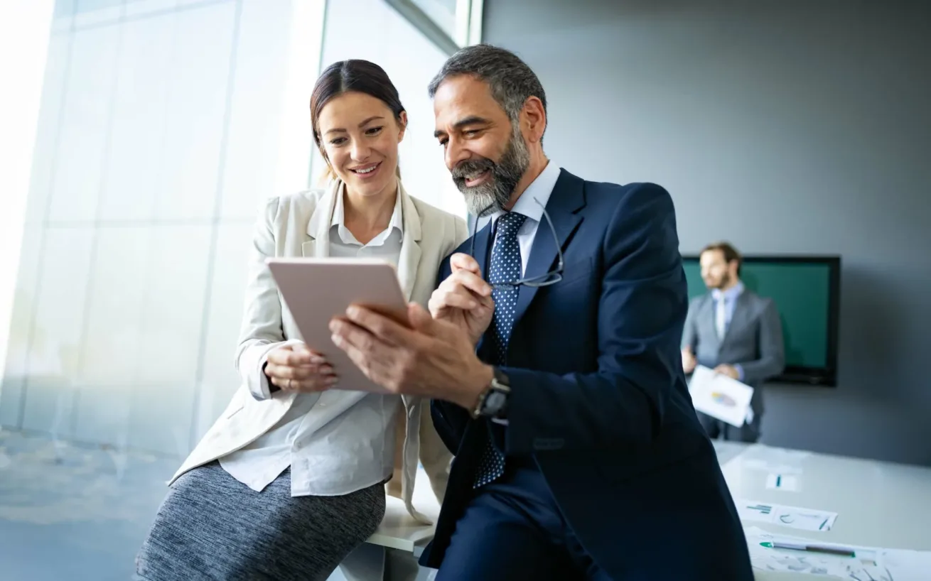 Business colleagues in modern office using tablet