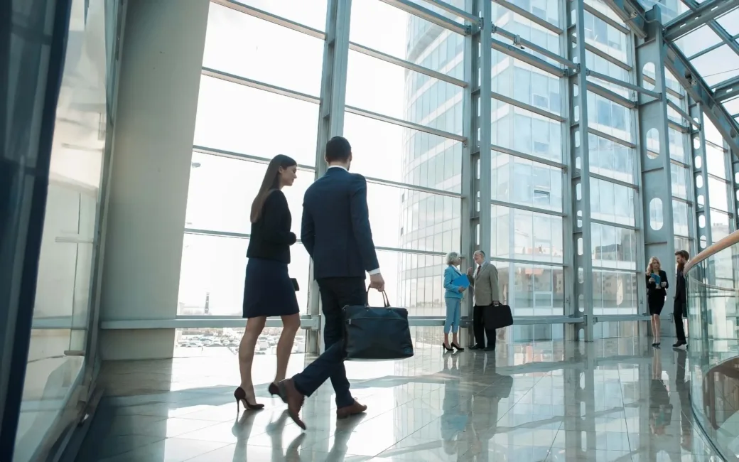 Business people walking on a modern walkway in office building