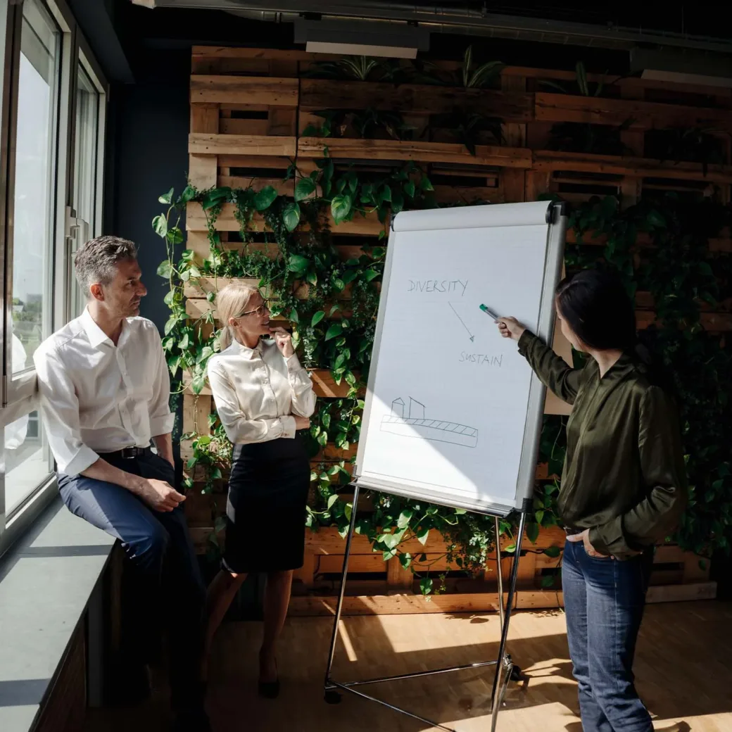 Business people working with flip chart in green office