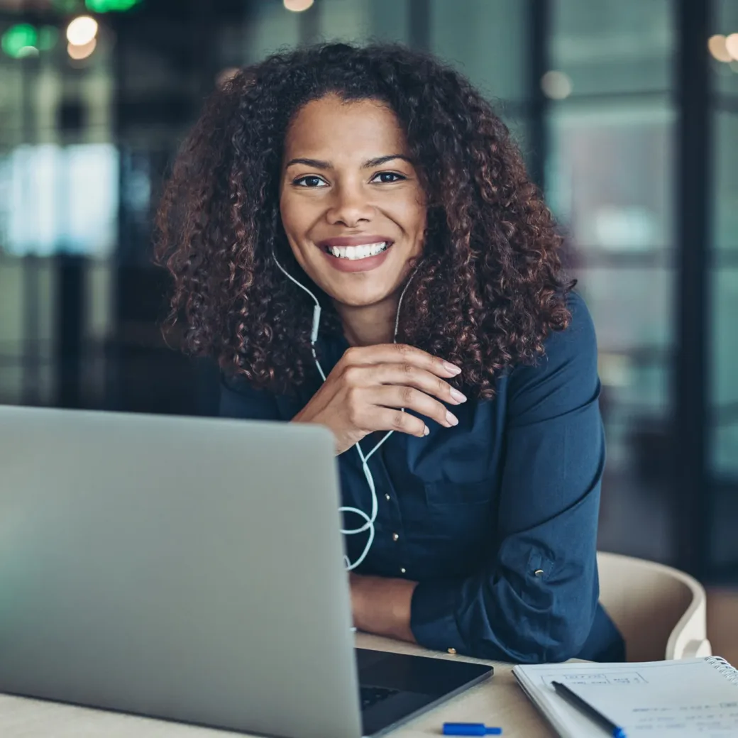 Businesswoman with laptop and headphones in the office