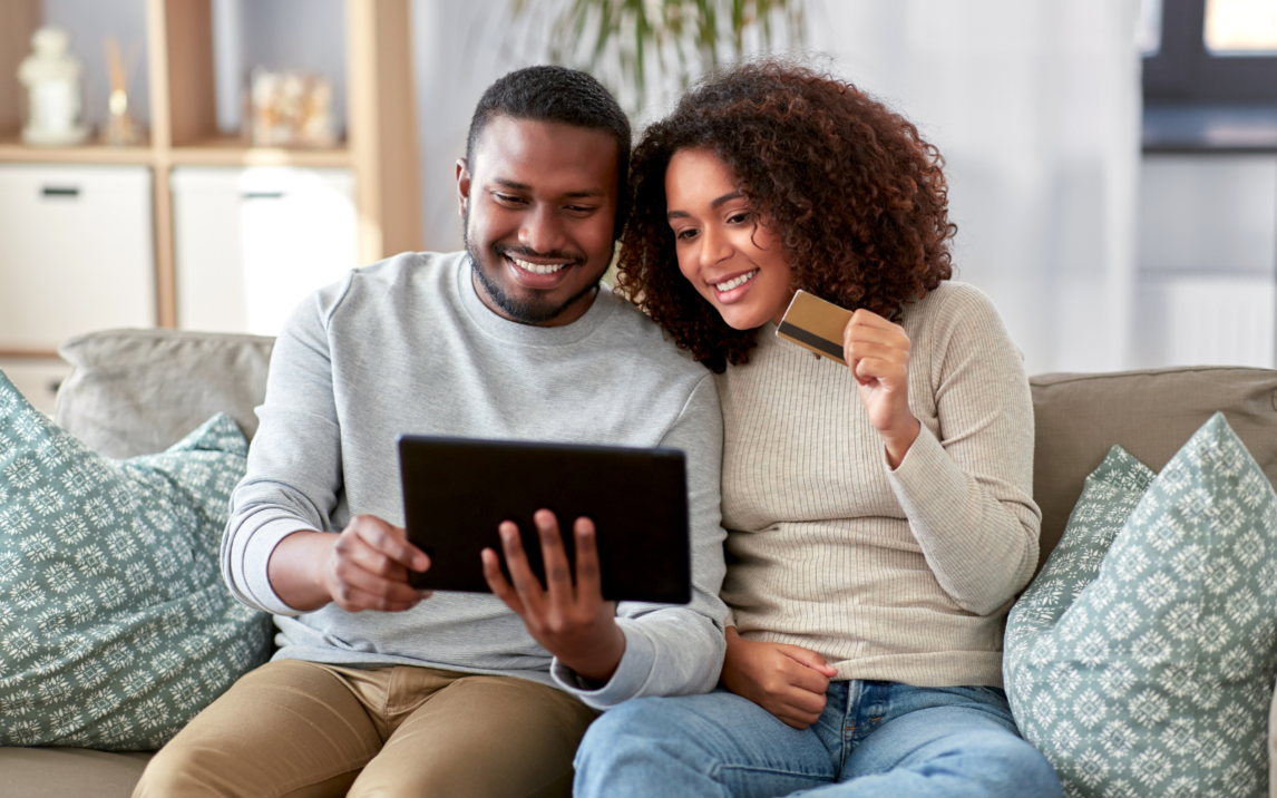 Picture of two people shopping online on a tablet