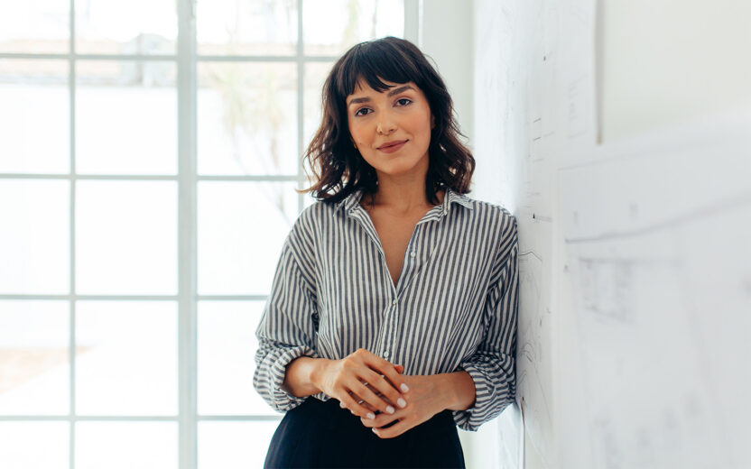 Businesswoman standing in office. Portrait of a confident businesswoman.