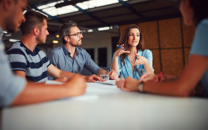 Shot of a group of coworkers having a meeting in an open plan office