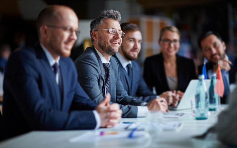 Successful businesspeople sitting at conference or seminar during lecture