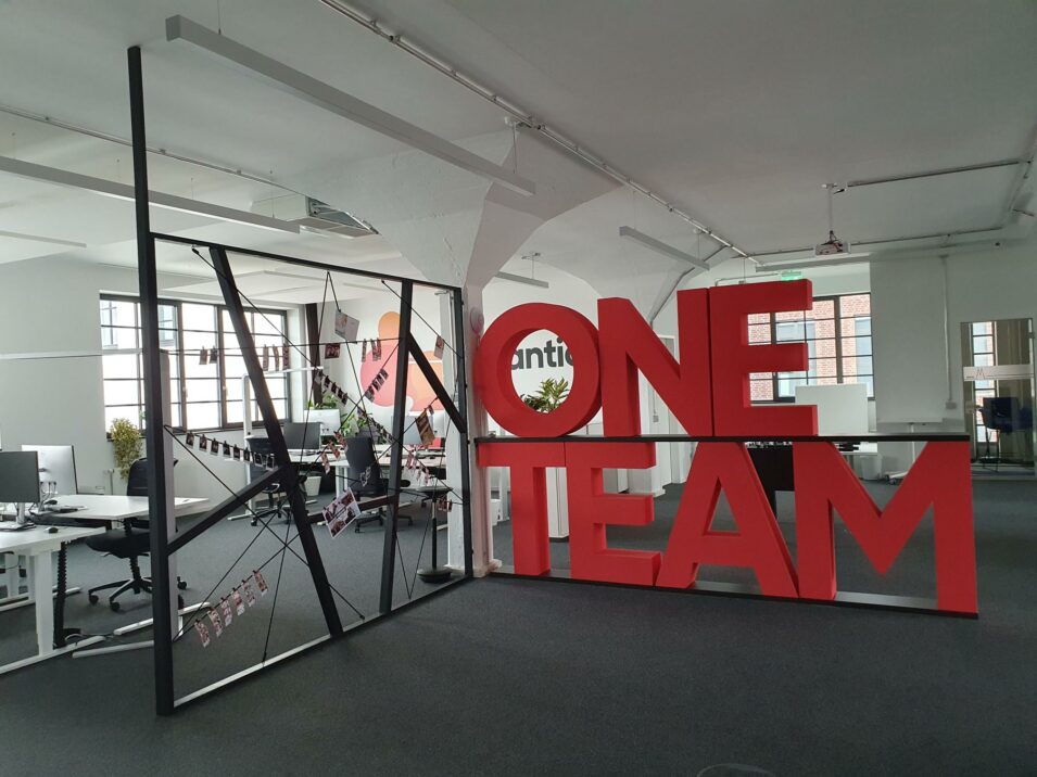 "One Team" standee at the vERP office in Cologne