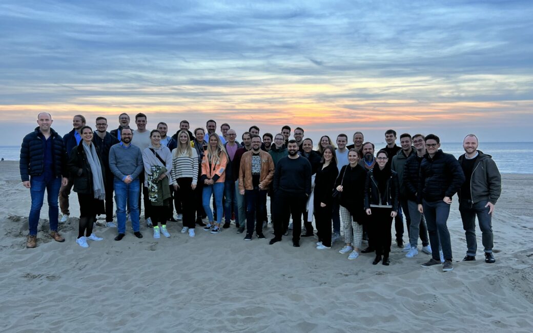 Gruppenbild von Mitarbeitenden von valantic in Köln bei Teamevent am Strand