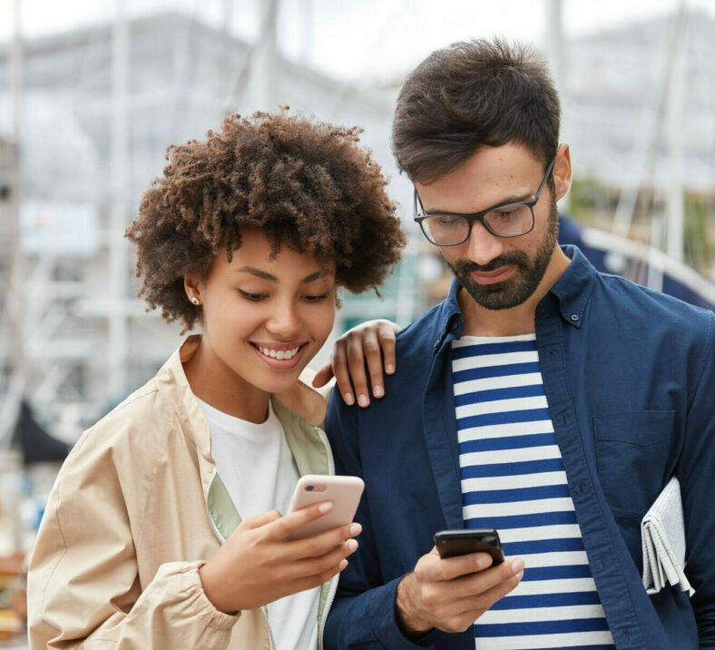 Two friends enjoying your phones