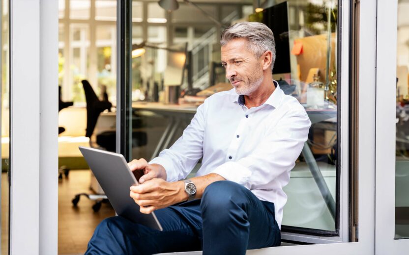 Businessman working on digital tablet while sitting