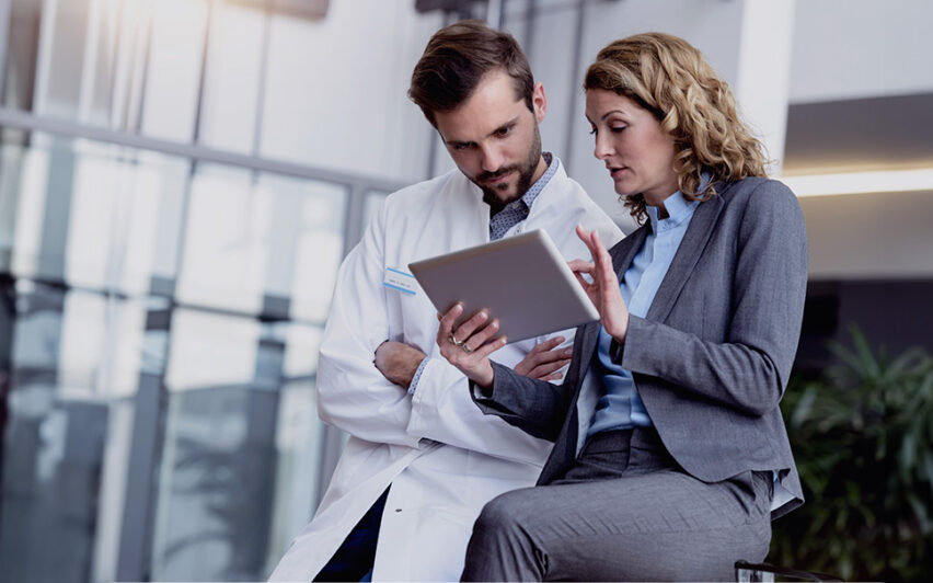 Businesswoman with tablet talking with doctor