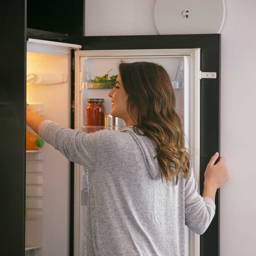 Woman by the open fridge