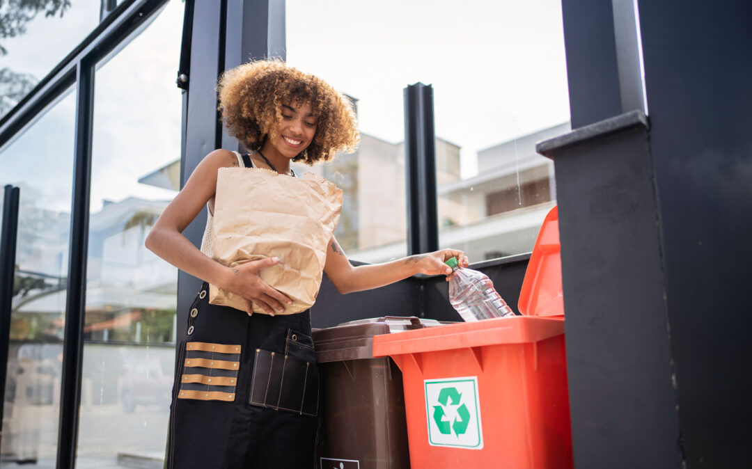 Young woman recycling garbage at home