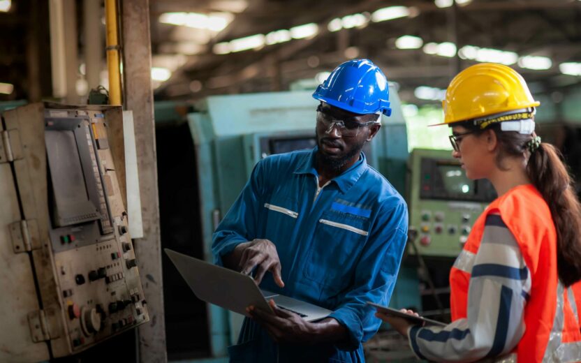 Man and female in a warehouse environment talking