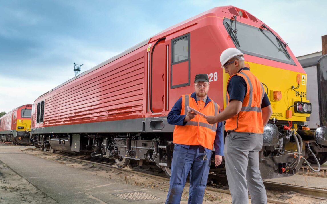 locomotive engineers in discussion beside locomotive