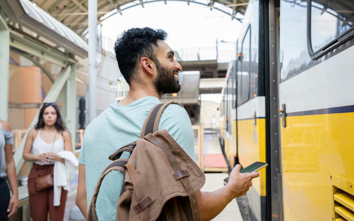 young man standing on train station platform