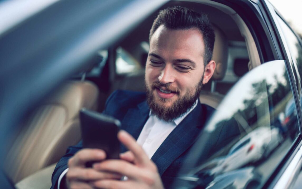 male businessman setting up a meeting via smartphone