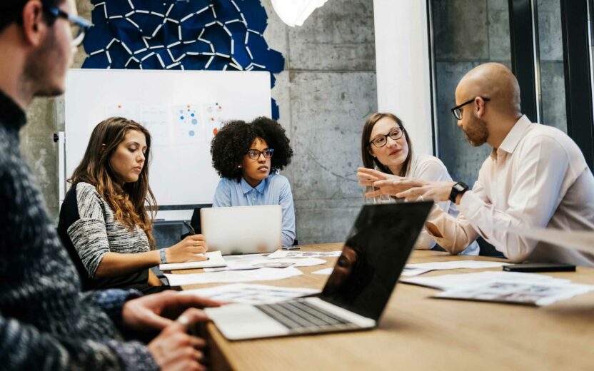 three women and two men in a business meeting