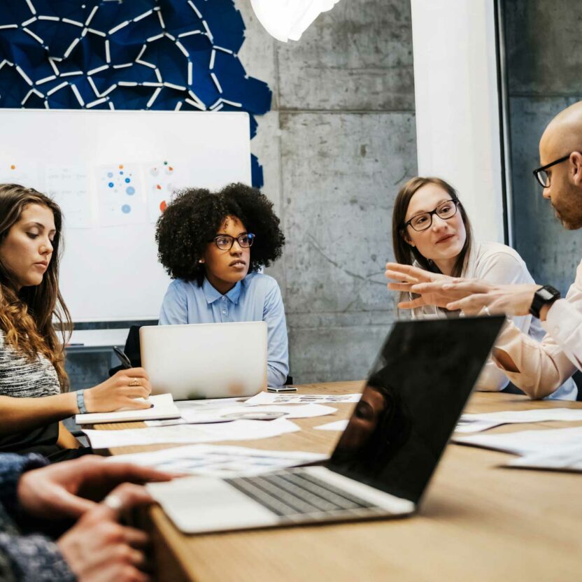 three women and two men in a business meeting