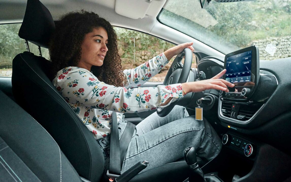 woman using digital radio in car