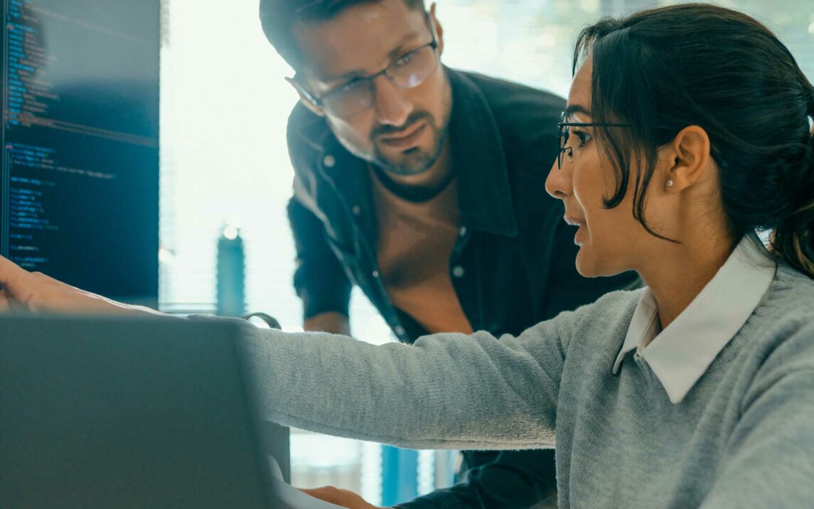 closeup of tech team professionals discussing software development strategies