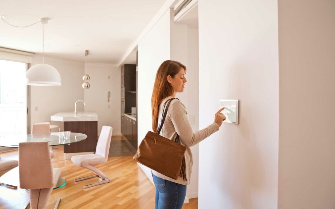 woman activating smart home security system