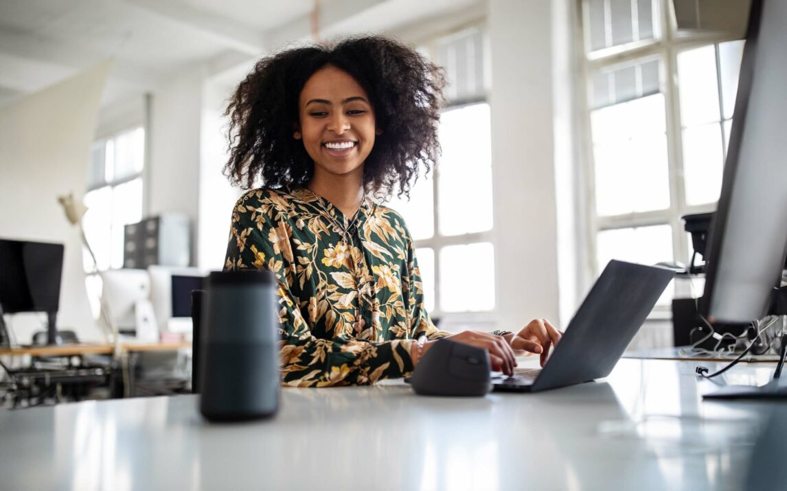 Woman using smart speaker while working in office