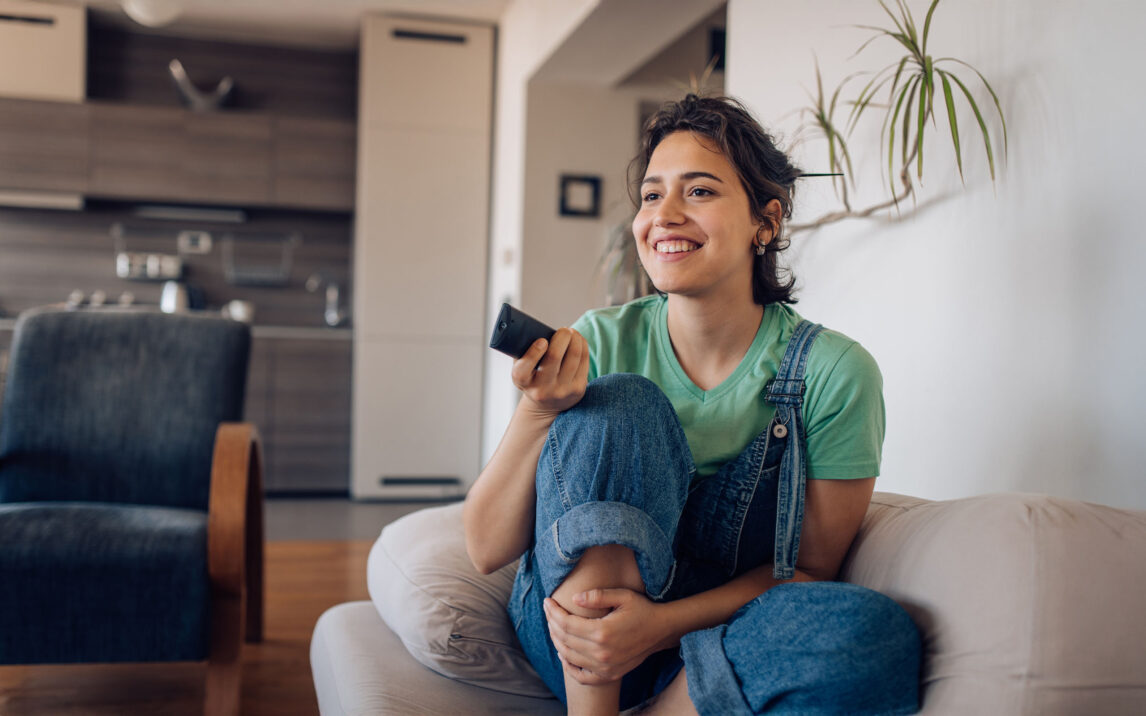 Woman enjoying tv show at home