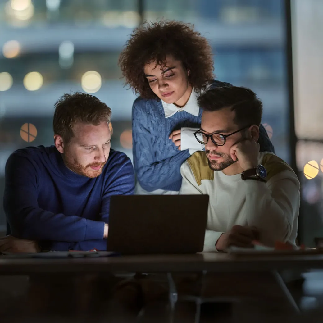 Business team working on a computer late in the office.