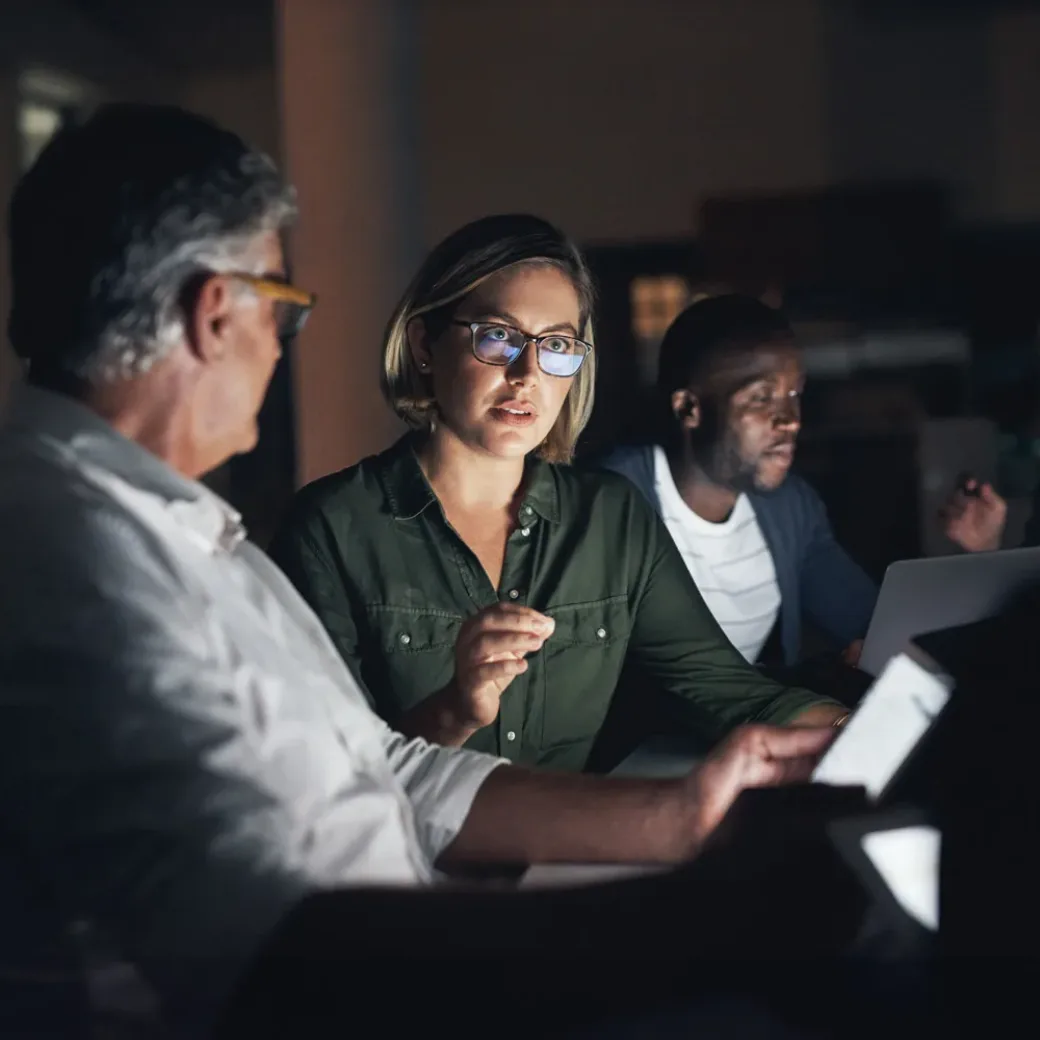 Shot of a group of colleagues having a meeting during a late night in a modern office